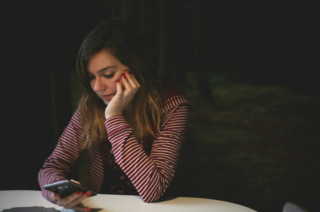 person checking phone anxiously