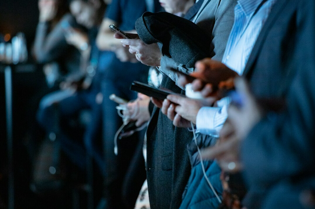 people using smartphones together