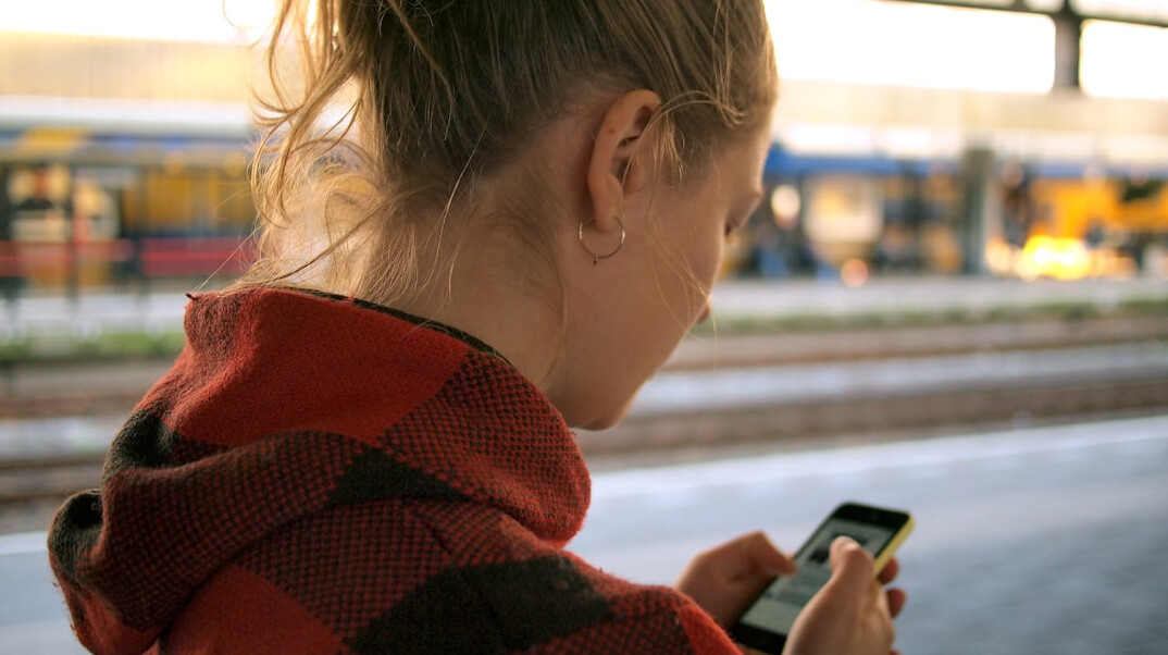 person scrolling on phone alone